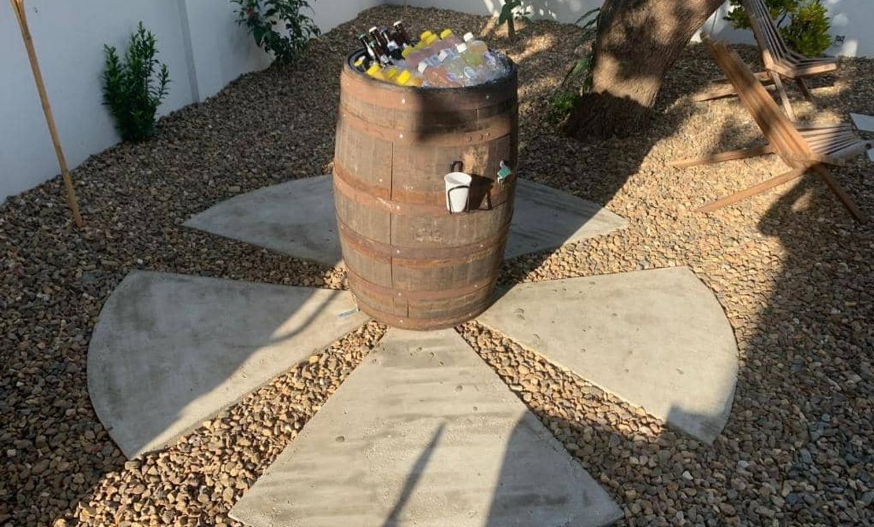 Wooden barrel ice cooler filled with bottled beverages