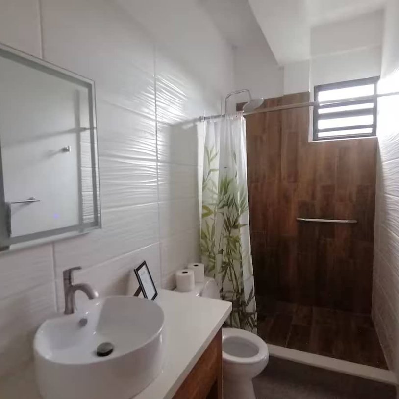 bathroom with a shower, sink and toliet.