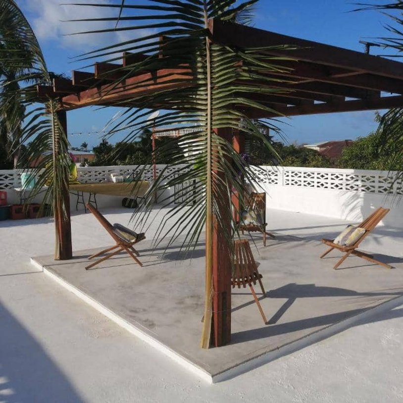 Rooftop terrace with wooden pergola and lounge chairs