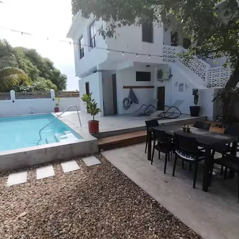 Backyard pool with patio dining area and furniture