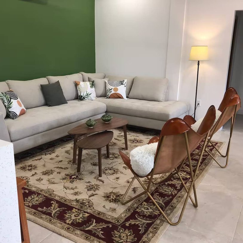 living room with a l-shaped couch and leather chair